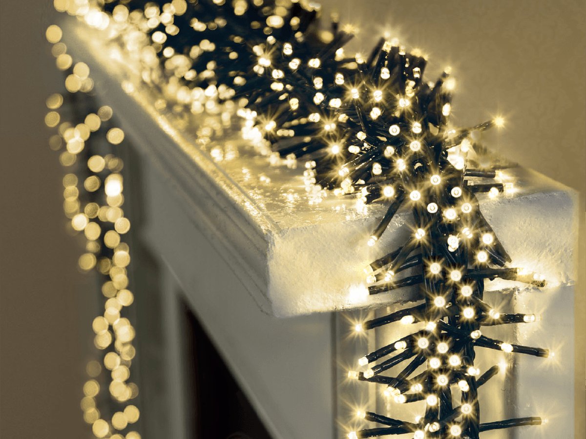 Dense warm white cluster lights on a fireplace mantel